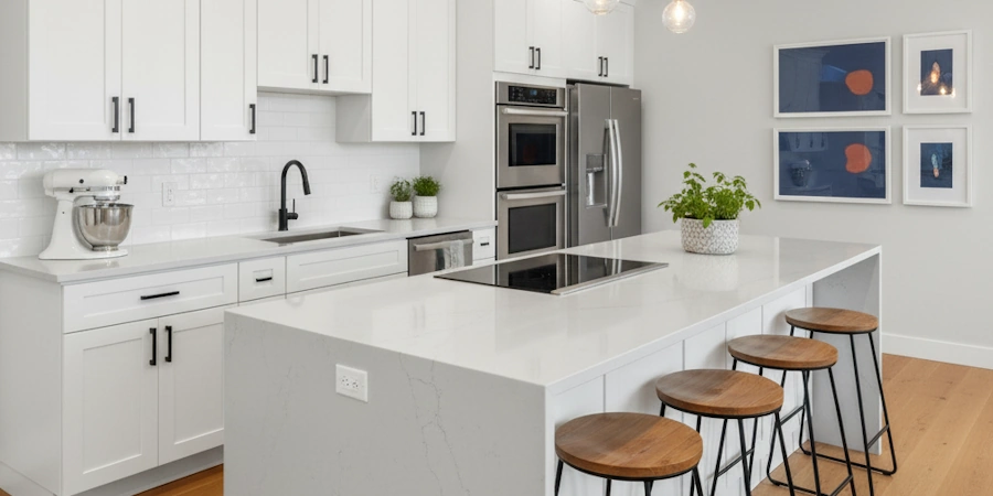 A modern kitchen with updated countertops and freshly painted cabinets.