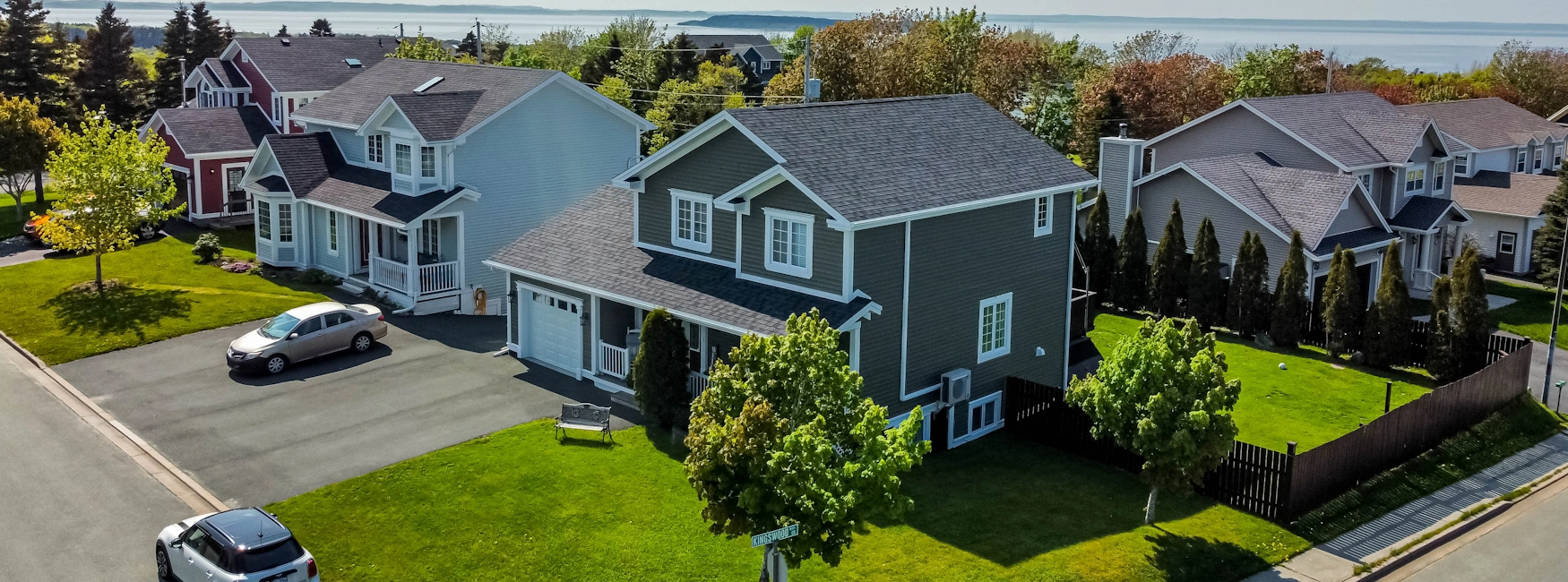 Spacious backyard with deck and playground area in Conception Bay South home