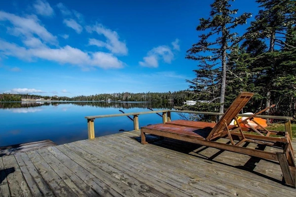 Scenic waterfront deck with lounge chairs overlooking a tranquil lake in Portugal Cove-St. Philip's.