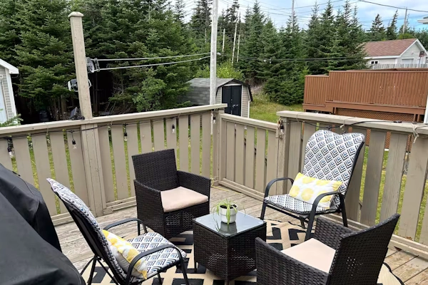 Cozy outdoor patio setup with seating area, surrounded by trees in Airport Heights, St. John's.