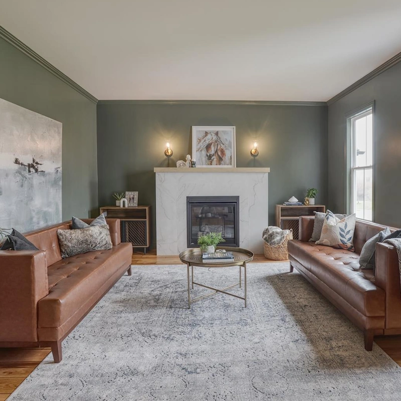 Modern living room with fireplace and leather sofas in a home for sale in Airport Heights, St. John's.