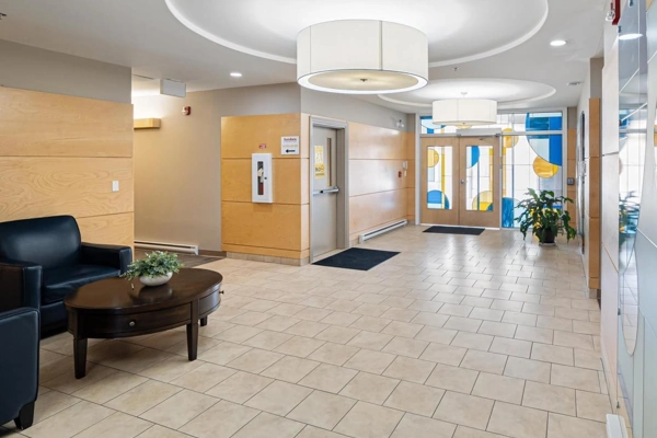Bright and welcoming condo lobby with modern decor and seating area.